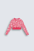 Pink patterned sweater on a light gray background